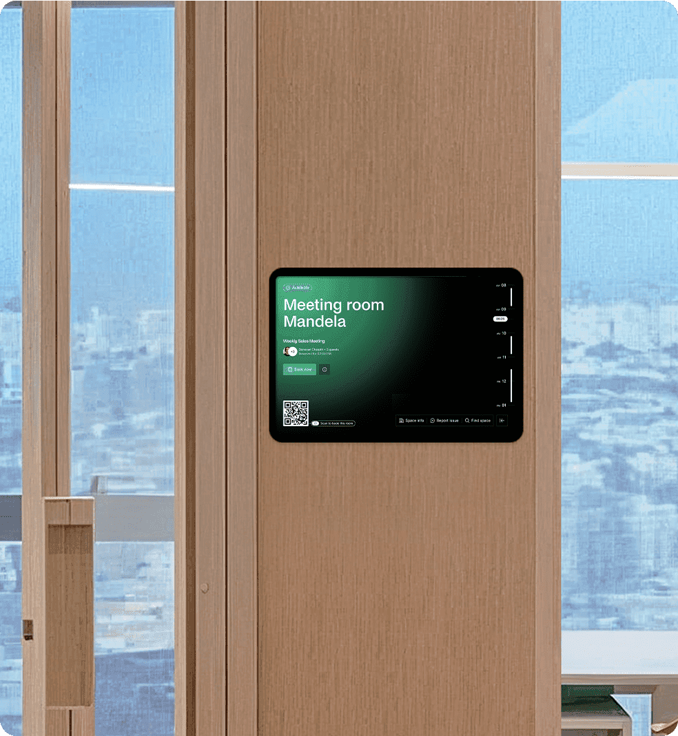 A tablet mounted outside a meeting room named "Mandela," showing booking information and a QR code for check-in.